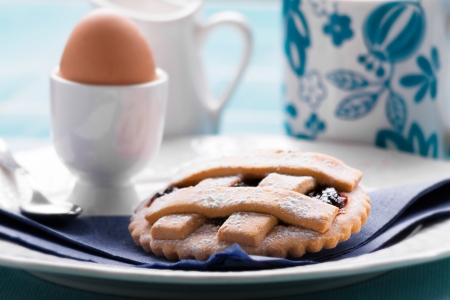 Breakfast jam tart, egg and beverageの写真素材