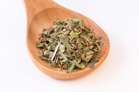 infusion leaves in wooden spoon closeup viewの写真素材