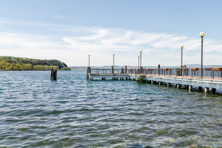 View of the jetty from the shore of Lake Bracciano Anguillara Lazio Italyの写真素材