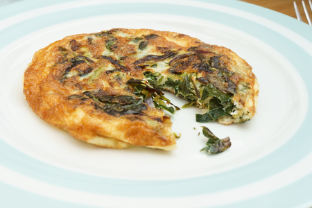 Homemade Frittata with onions, vegetable and parmesan cheese.の写真素材