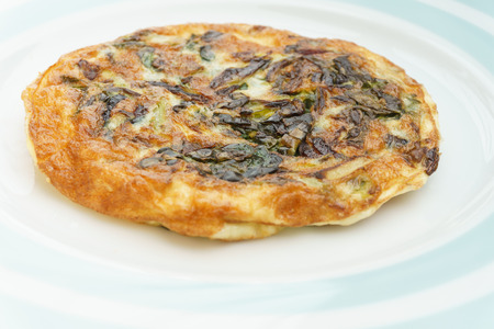 Homemade Frittata with onions, vegetable and parmesan cheese.の写真素材