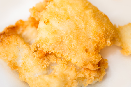 Homemade fried cod on white background - closeupの写真素材