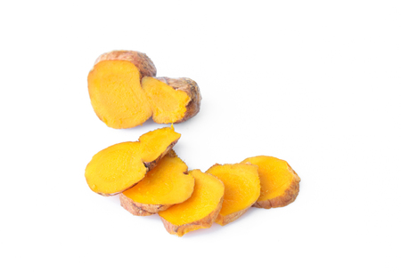 Closeup turmeric roots slices on white backgroundの写真素材