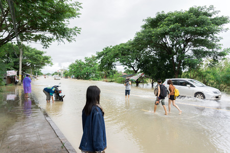 SAKON NAKHON, THAILAND - JULY 29, 2017 : People walking in streets water floodedのeditorial素材