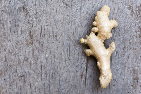 Closeup ginger roots with wood background, coppy space for text or ginger product conceptの写真素材