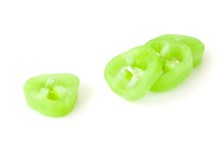 Green chilli pepper with sliced on white background, raw food ingredient conceptの写真素材