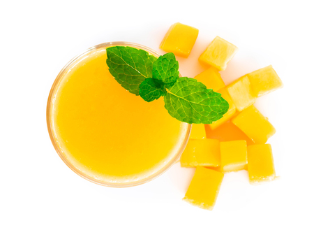 Closeup glass of mango fruit juice isolated on white backgroundの写真素材
