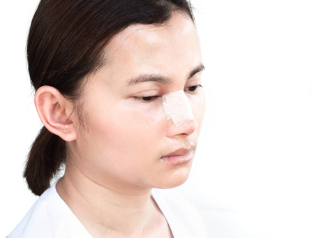 Close up face of asian woman with nose plastic surgery for beauty and cosmetic conept, white backgroundの写真素材