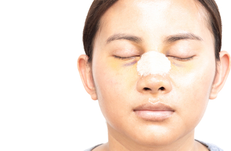 Close up face of asian woman with nose plastic surgery for beauty and cosmetic conept, white backgroundの写真素材