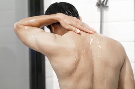 Closeup handsome asian man taking a shower in the bathroom, selective focusの写真素材