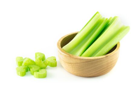 Fresh celery vegetable in wood bowl and sliced  isolated on white background, food for healthの写真素材