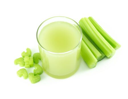 Glass of fresh celery juice isolated on white background, food for healthの写真素材