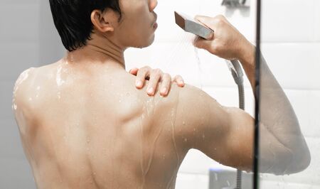 Closeup handsome asian man taking a shower in the bathroom, selective focusの写真素材