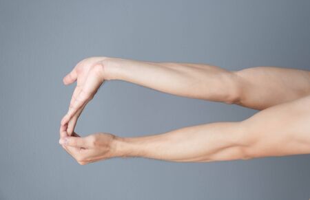 stretching exercises finger on grey background, health care and medical conceptの写真素材