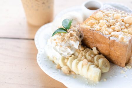 Honey toast dessert with ice coffee on wood tableの写真素材
