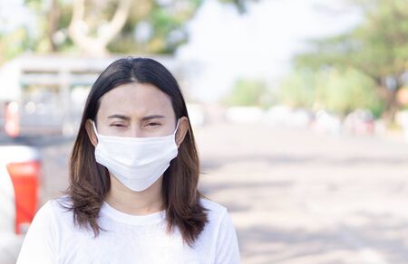Closeup woman wearing face mask for protect air polution or colona virus, health care and medical conceptの写真素材