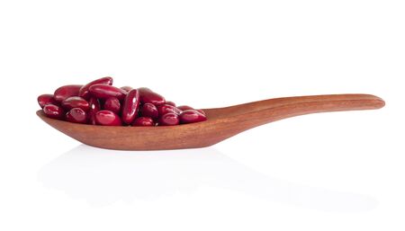 Red kidney beans in wood spoon isolated on white background, healthy food conceptの写真素材