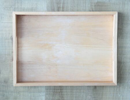Empty wooden tray on wood table background, Top viewの写真素材