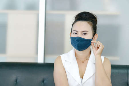 Closeup asian woman wearing face mask for protect air polution or virus covid 19, health care and...