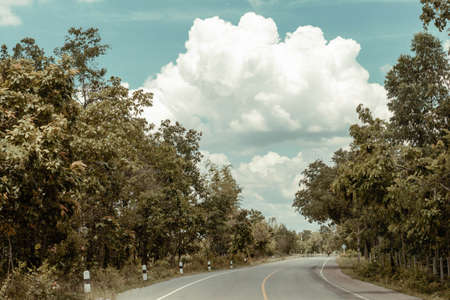 Country road with clouds and blue sky の写真素材