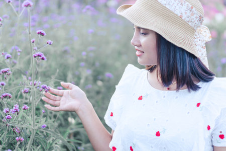 Portrait of asian happy woman smilling with flower garden , Selective focusの写真素材