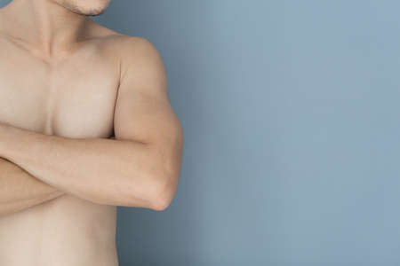 Closeup asian man crossed hand with blue background, health care concept