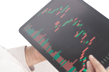 Business woman hand holding digital tablet computer with graph of Binary option for trading...