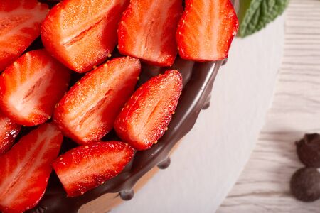 Mousse cake with profiteroles inside and strawberriesの写真素材