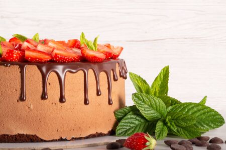 Mousse cake with profiteroles inside and strawberriesの写真素材