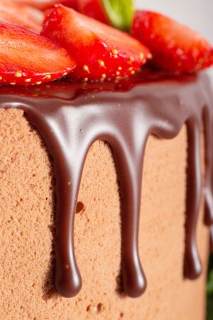 Mousse cake with profiteroles inside and strawberriesの写真素材