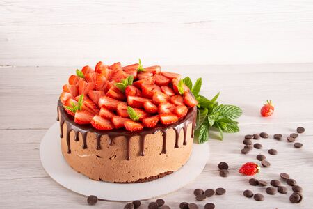 Mousse cake with profiteroles inside and strawberriesの写真素材