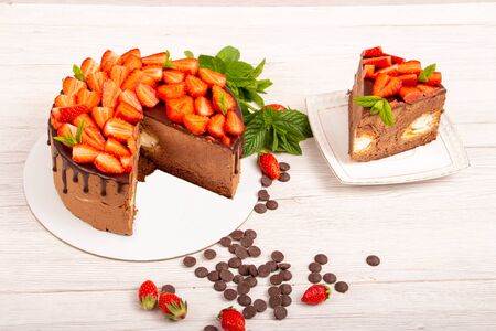 Mousse cake with profiteroles inside and strawberriesの写真素材
