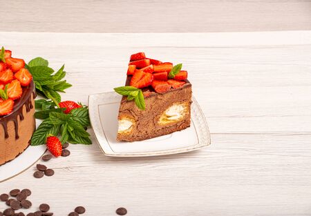 Mousse cake with profiteroles inside and strawberriesの写真素材