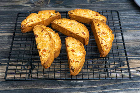 Biscotti with orange filling on a dark tableの写真素材