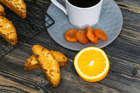 Biscotti with orange filling on a dark tableの写真素材