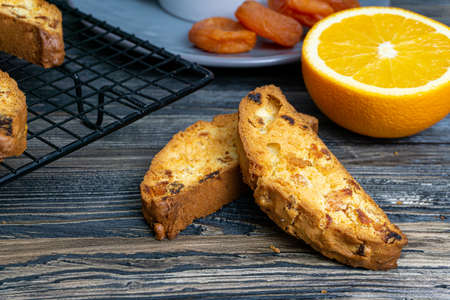 Biscotti with orange filling on a dark tableの写真素材