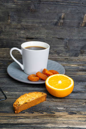 Biscotti with orange filling on a dark tableの写真素材