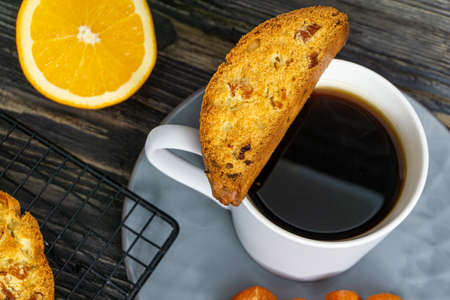 Biscotti with orange filling on a dark tableの写真素材
