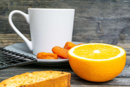 Biscotti with orange filling on a dark tableの写真素材