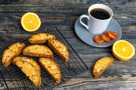 Biscotti with orange filling on a dark tableの写真素材