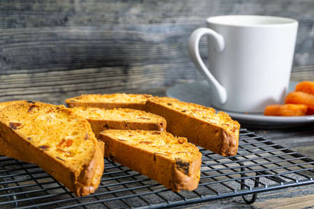 Biscotti with orange filling on a dark tableの写真素材
