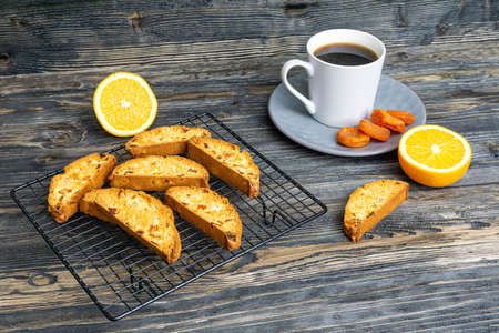 Biscotti with orange filling on a dark tableの写真素材