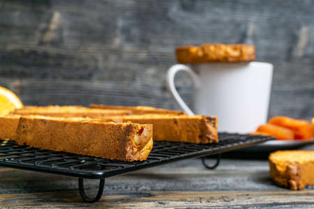 Biscotti with orange filling on a dark tableの写真素材