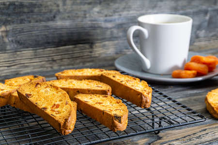 Biscotti with orange filling on a dark tableの写真素材