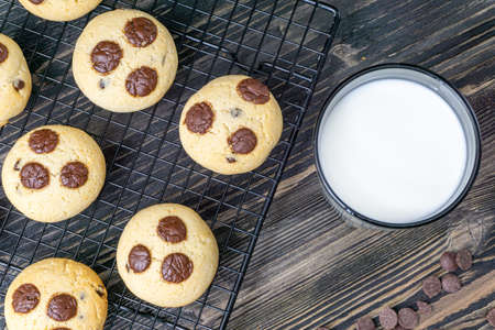 Cookies with pieces of round chocolate on a dark backgroundの写真素材