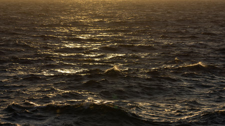 Sunset on the Atlantic Ocean with waves and spray. Toned.の写真素材