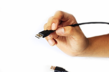 USB cable with hand on white background