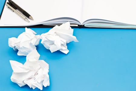 Used paper and blank page on the blue deskの写真素材