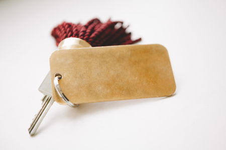 Tassel key tag on pale grey backgroundの写真素材