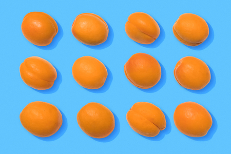 Apricots on blue backgroundの写真素材
